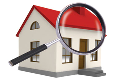 Magnifying glass looking at a home